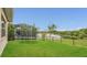 Expansive backyard with lush green grass, trampoline, and beautiful water view at 13125 Alderley Dr, Orlando, FL 32832