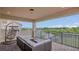 Balcony with comfortable outdoor seating and a relaxing hanging chair with views of the lake at 13125 Alderley Dr, Orlando, FL 32832