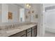 Bathroom featuring granite countertops, double sinks, and a decorative mirror at 13125 Alderley Dr, Orlando, FL 32832