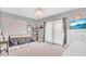 Bedroom with a queen bed, a crystal chandelier, and doors leading to a balcony at 13125 Alderley Dr, Orlando, FL 32832