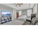 Bedroom with a flat screen TV, gray paint, tray ceiling, and a ceiling fan at 13125 Alderley Dr, Orlando, FL 32832