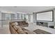 Upstairs bonus room with a large sectional sofa and a large projector screen for entertainment at 13125 Alderley Dr, Orlando, FL 32832