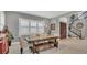 Dining area with a wood table, bench seating, and large windows with plantation shutters at 13125 Alderley Dr, Orlando, FL 32832