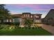 Inviting home featuring a tile roof, manicured lawn, and a brick-paved driveway, providing curb appeal at 13125 Alderley Dr, Orlando, FL 32832