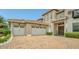 Three-car garage featuring a paver driveway, and a covered front entrance at 13125 Alderley Dr, Orlando, FL 32832