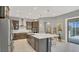 Gourmet kitchen features a large island, stainless steel appliances, and stylish pendant lighting at 13125 Alderley Dr, Orlando, FL 32832