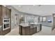 Open kitchen design with an island, stainless steel sink, and modern appliances overlooking living area at 13125 Alderley Dr, Orlando, FL 32832