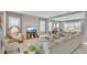 Spacious living room featuring tile floors, a stacked stone accent wall, and oversized sectional seating at 13125 Alderley Dr, Orlando, FL 32832