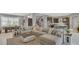 Open-concept living room featuring a large sectional sofa, rug, and an eat-in kitchen at 13125 Alderley Dr, Orlando, FL 32832