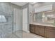 Modern bathroom with a glass walk-in shower and dual vanities with granite countertops at 13125 Alderley Dr, Orlando, FL 32832