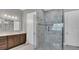 Modern bathroom with a glass walk-in shower and dual vanities with granite countertops at 13125 Alderley Dr, Orlando, FL 32832