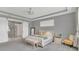 Relaxing bedroom featuring carpeted floors and an ensuite bathroom with a sliding barn door at 13125 Alderley Dr, Orlando, FL 32832