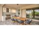 Outdoor kitchen with stainless steel appliances and dining table under a covered patio at 13125 Alderley Dr, Orlando, FL 32832