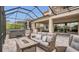 Covered patio with stylish outdoor seating, fire pit, and outdoor kitchen perfect for entertaining at 13125 Alderley Dr, Orlando, FL 32832