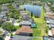 An aerial view of neighborhood homes surrounding a serene lake at 14883 Hartford Run Dr, Orlando, FL 32828
