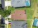 Birds eye view of a home with a brown roof, screened in patio, and a community pool nearby at 14883 Hartford Run Dr, Orlando, FL 32828