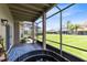 Screened porch featuring a cozy nook and picturesque views of the expansive backyard at 14883 Hartford Run Dr, Orlando, FL 32828