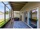 Cozy screened-in porch featuring comfortable seating and tranquil views at 14883 Hartford Run Dr, Orlando, FL 32828