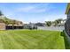 Expansive backyard showcasing a lush lawn, mature trees, and neighboring homes at 14883 Hartford Run Dr, Orlando, FL 32828
