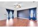 Generously sized bedroom with wood floors, balcony access and blue accent wall at 14883 Hartford Run Dr, Orlando, FL 32828