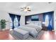 Inviting main bedroom with balcony, tray ceilings, blue accent wall and elegant decor at 14883 Hartford Run Dr, Orlando, FL 32828