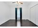 A pristine bedroom with hardwood floors, a ceiling fan and bright, natural light at 14883 Hartford Run Dr, Orlando, FL 32828