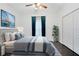 Comfortable bedroom with a plush bed, stylish bedding, and large windows at 14883 Hartford Run Dr, Orlando, FL 32828
