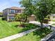 Charming two-story home with lush green lawn, palm trees and mature trees at 14883 Hartford Run Dr, Orlando, FL 32828
