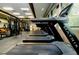 Well-equipped gym with treadmills and weight machines next to windows at 14883 Hartford Run Dr, Orlando, FL 32828
