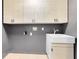 Bright laundry room featuring upper cabinets and a utility sink at 14883 Hartford Run Dr, Orlando, FL 32828