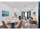 A bright dining and living space with dark hardwood flooring and bay window at 14883 Hartford Run Dr, Orlando, FL 32828