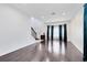 Bright living room with hardwood floors, large window, and staircase at 14883 Hartford Run Dr, Orlando, FL 32828