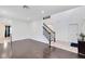 Open-concept living room with dark hardwood flooring and staircase at 14883 Hartford Run Dr, Orlando, FL 32828