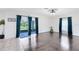 Open living area with tile and hardwood floors, leading to a screened lanai at 14883 Hartford Run Dr, Orlando, FL 32828