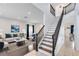 Inviting living room features a staircase and views to the formal living areas at 14883 Hartford Run Dr, Orlando, FL 32828