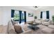 Comfortable living room with plush seating and access to a screened patio at 14883 Hartford Run Dr, Orlando, FL 32828