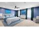Stylish main bedroom featuring blue walls, a ceiling fan, and matching curtains and decor at 14883 Hartford Run Dr, Orlando, FL 32828