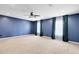 Expansive main bedroom with neutral carpet, blue accent wall, and bright natural light at 14883 Hartford Run Dr, Orlando, FL 32828