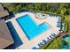 Aerial view of the community pool with lap lanes, blue lounge chairs, and water fountain at 14883 Hartford Run Dr, Orlando, FL 32828