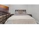 Well-furnished bedroom featuring a wooden bed frame with soft bedding, a TV on the dresser, and neutral color scheme at 14925 Lebeau Loop, Winter Garden, FL 34787