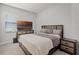Comfortable bedroom with a wooden bed frame, soft bedding, a TV on the dresser, and neutral colors at 14925 Lebeau Loop, Winter Garden, FL 34787