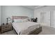 Charming bedroom featuring a light wood bed frame and side tables, complemented by cool blue wall accents at 14925 Lebeau Loop, Winter Garden, FL 34787