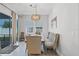 Bright dining room with natural light, wooden table, upholstered chairs and bench, with sliding glass doors to the outside at 14925 Lebeau Loop, Winter Garden, FL 34787