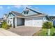 Corner-lot home with two-car garage, brick driveway, and landscaped yard at 14925 Lebeau Loop, Winter Garden, FL 34787