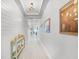 Bright hallway with decorative lighting, shiplap accent wall, and wood-look tile flooring at 14925 Lebeau Loop, Winter Garden, FL 34787