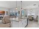 Open-concept kitchen with island, stainless steel appliances, and views of the living and dining area at 14925 Lebeau Loop, Winter Garden, FL 34787