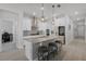 Bright kitchen featuring a large island, stainless steel appliances, and modern gray backsplash at 14925 Lebeau Loop, Winter Garden, FL 34787