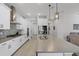 Bright, modern kitchen with white cabinets, stainless steel appliances, and large center island with pendant lighting at 14925 Lebeau Loop, Winter Garden, FL 34787