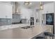Close up of the island and appliances in a kitchen with an island and modern gray backsplash at 14925 Lebeau Loop, Winter Garden, FL 34787