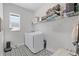 Functional laundry room featuring modern appliances, stylish flooring, and ample storage space at 14925 Lebeau Loop, Winter Garden, FL 34787